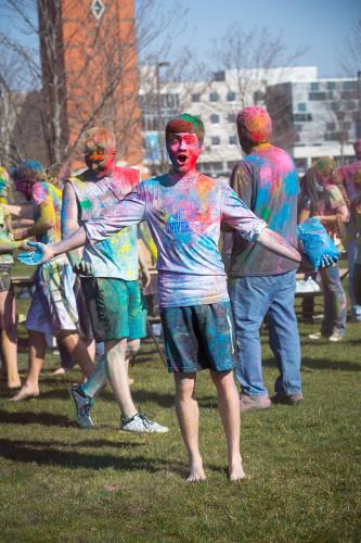 HOLI 2016 male student smiling in front of clock tower